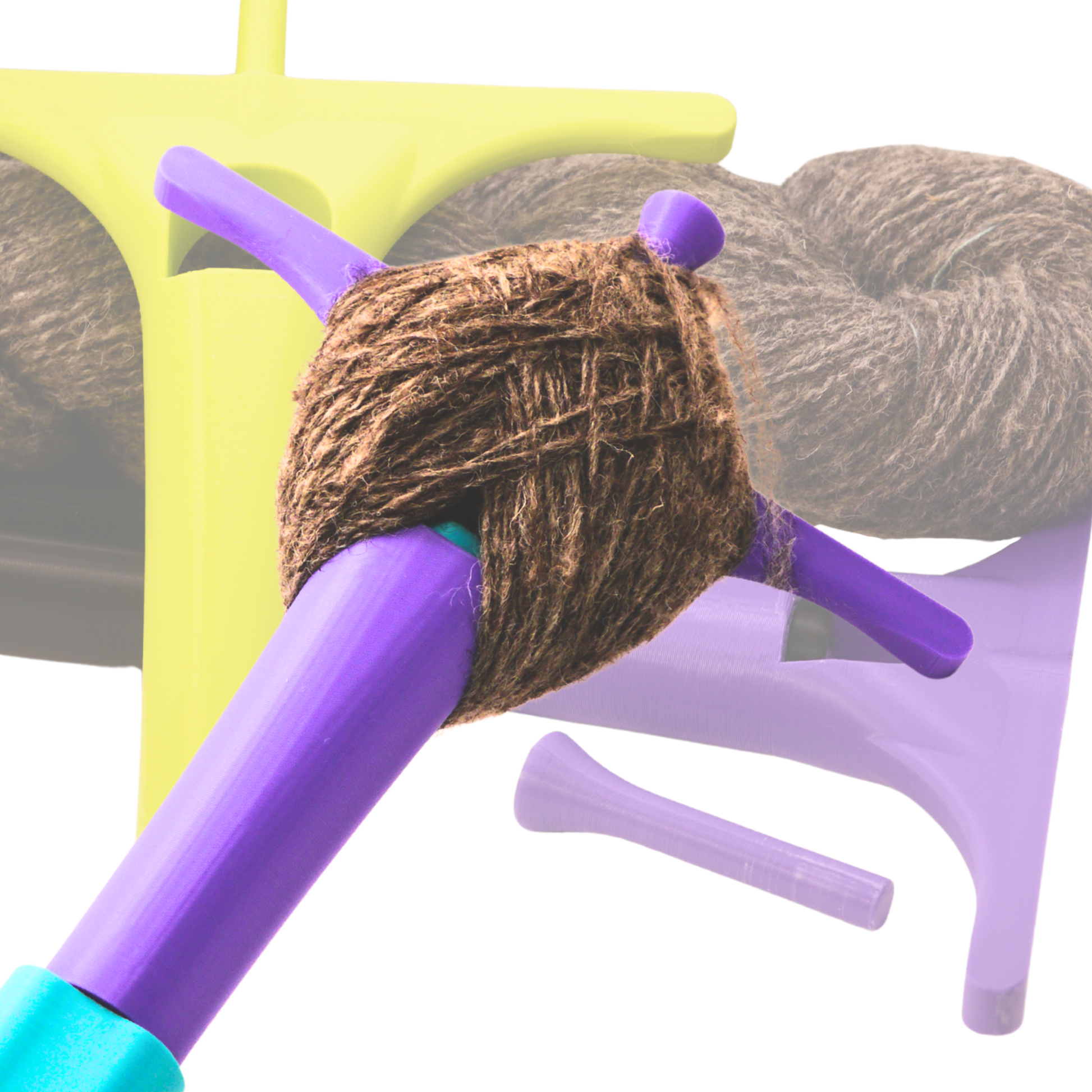 the background features two plying drugas against a skein of grey yarn. The foreground shows a plying druga mid-spin with yarn wrapped around the peg