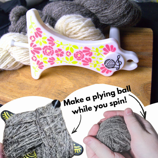 a white and pink floral mayan spinner with a background of handspun yarn. The foreground graphics say 'make a plying ball while you spin' with a fully wrapped paddle and some hands holding the removed ball of single spun yarn, ready to ply from