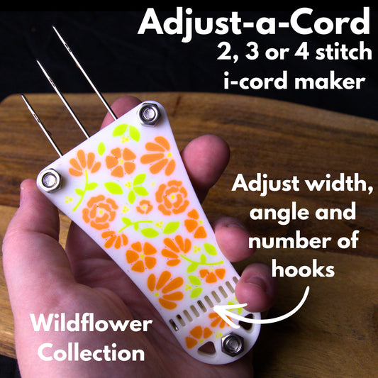 A white adjust-a-cord i-cord maker with orange floral designs on it. Text reads 'adjust-a-cord. 2, 3 or 4 stitch i-cord maker. adjust width, angle and number of hooks. Wildflower Collection'