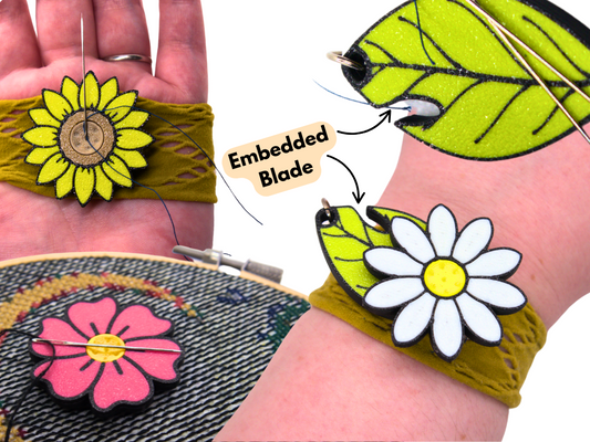 flower and leaf-shaped sewing tool that can be used as a palm thimble, needle minder, wrist pin cushion and a thread cutter