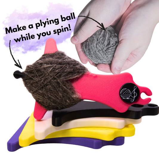 a hand holding a ball of spun single yarn to ply from alongside a pile of colourful mayan spin and ply spinners with the caption make a plying ball while you spin