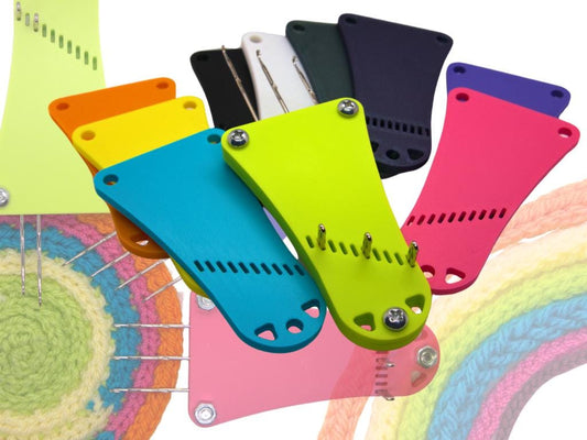 Colorful plastic knitted i-cord making tools on a white background