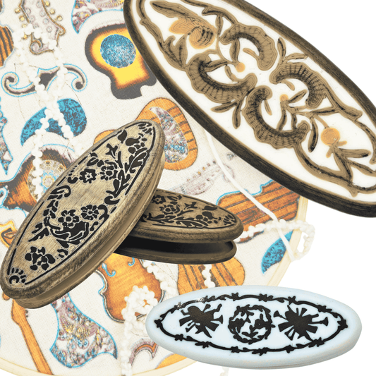 examples of historically inspired knotting shuttles with some embroidery knotwork of a treble clef in the background