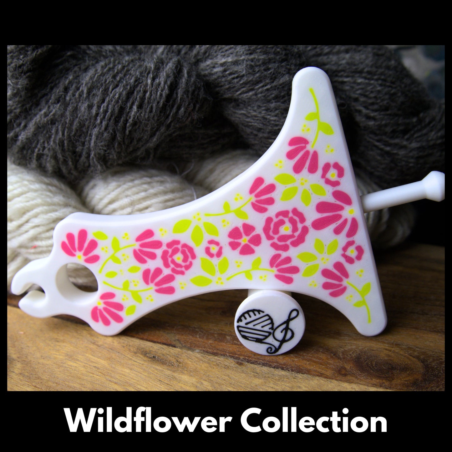 a white and pink floral mayan paddle spinner with the label 'wildflower collection'