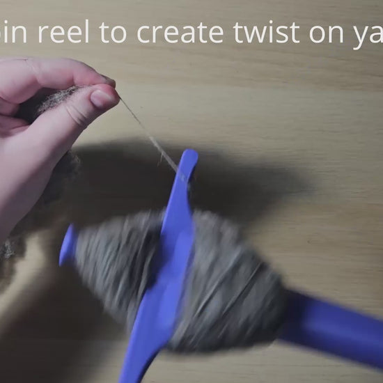 a video demonstrating how to use the plying druga. Text reads 'create spin on yarn' while my hands are rotating the reel, then 'draft yarn' (also suitable for one-handed draw) while showing me doing the park and draft method of spinning, allowing the twist I just created to travel down my fiber supply. Then the instruction 'wrap yarn around peg' (guide in listing pictures) shows me wrapping the now spun single onto the tool in the correct way in order to achieve a plying ball. Plying ball removal follows